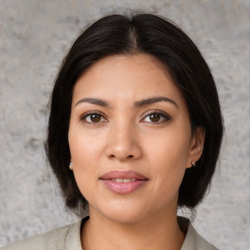 Joyful asian young-adult female with medium  brown hair and brown eyes