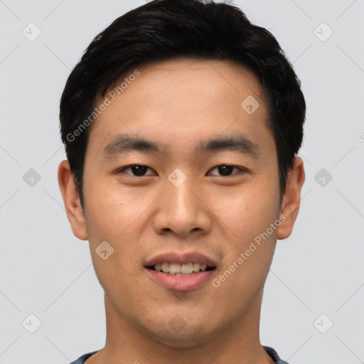 Joyful asian young-adult male with short  black hair and brown eyes