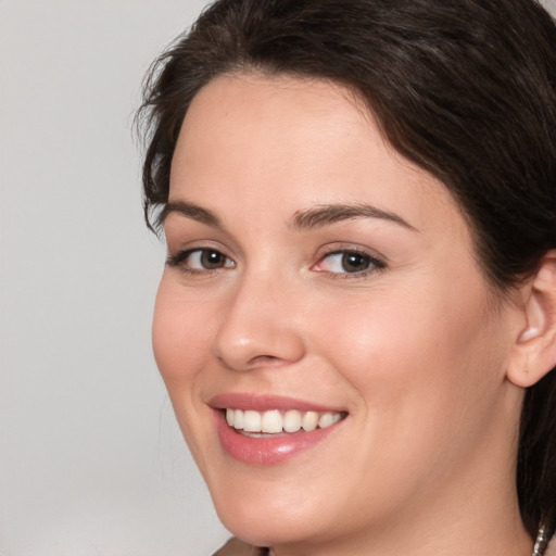 Joyful white young-adult female with medium  brown hair and brown eyes