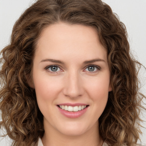 Joyful white young-adult female with long  brown hair and green eyes