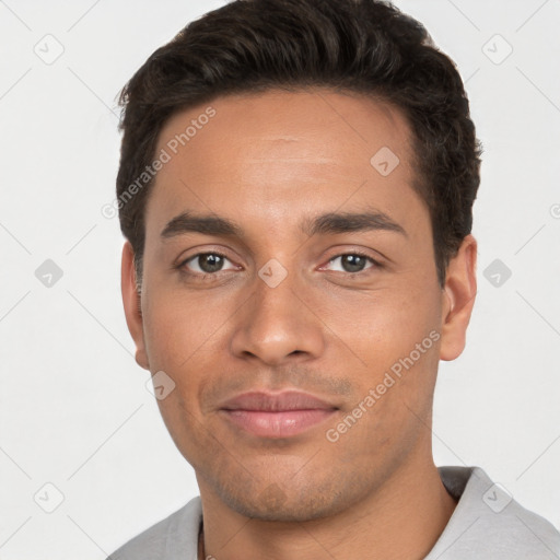 Joyful white young-adult male with short  black hair and brown eyes