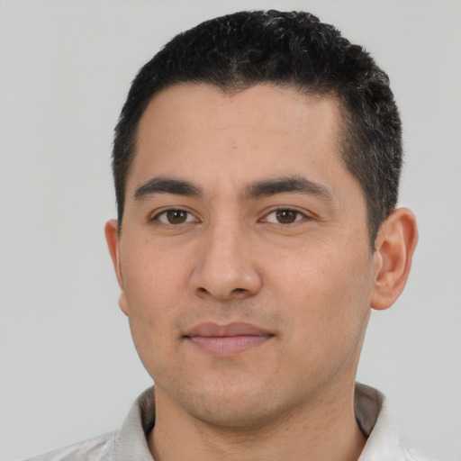 Joyful white young-adult male with short  black hair and brown eyes