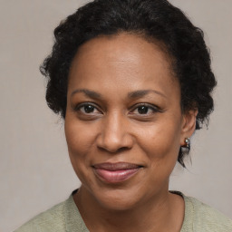 Joyful black adult female with medium  brown hair and brown eyes