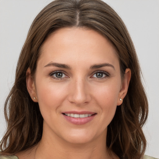 Joyful white young-adult female with long  brown hair and grey eyes