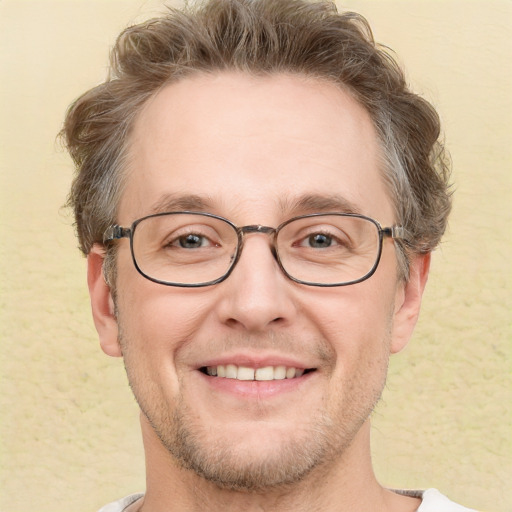 Joyful white adult male with short  brown hair and grey eyes