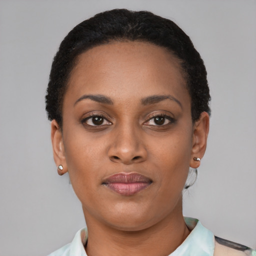 Joyful black young-adult female with short  brown hair and brown eyes