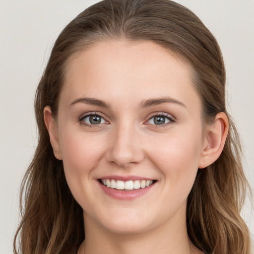 Joyful white young-adult female with long  brown hair and grey eyes