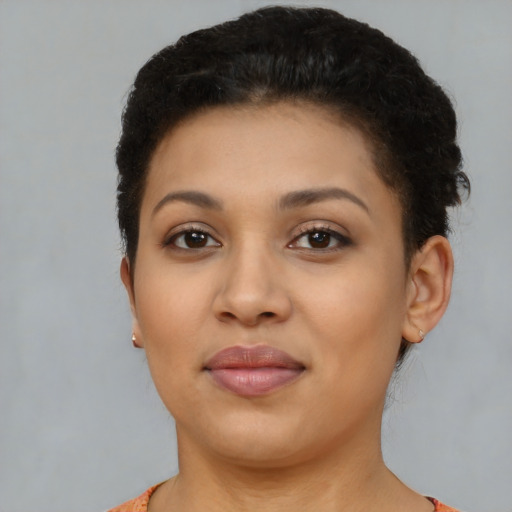 Joyful latino young-adult female with short  brown hair and brown eyes