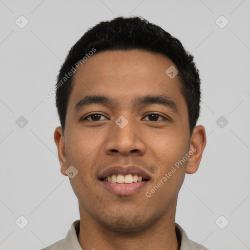 Joyful latino young-adult male with short  black hair and brown eyes