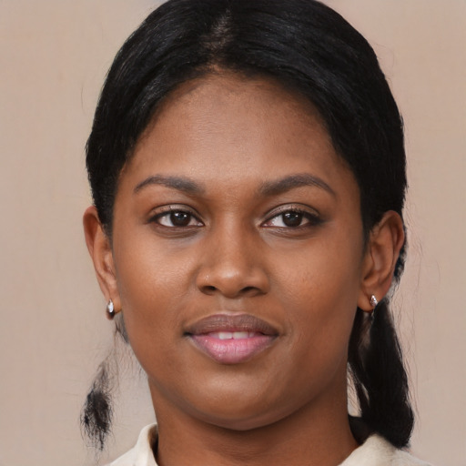 Joyful black young-adult female with medium  black hair and brown eyes