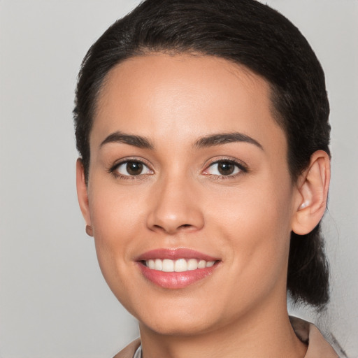 Joyful white young-adult female with medium  black hair and brown eyes