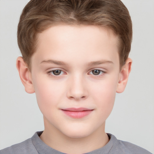 Joyful white child male with short  brown hair and grey eyes