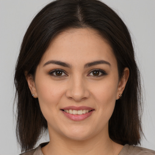 Joyful white young-adult female with medium  brown hair and brown eyes
