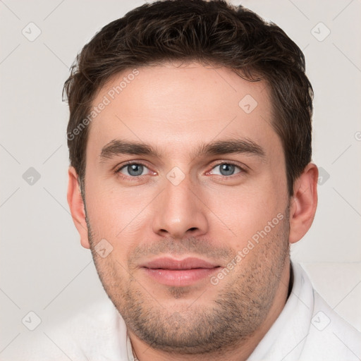 Joyful white young-adult male with short  brown hair and brown eyes