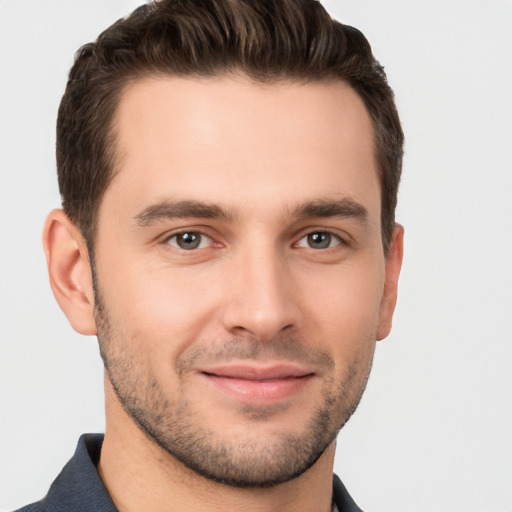 Joyful white young-adult male with short  brown hair and brown eyes