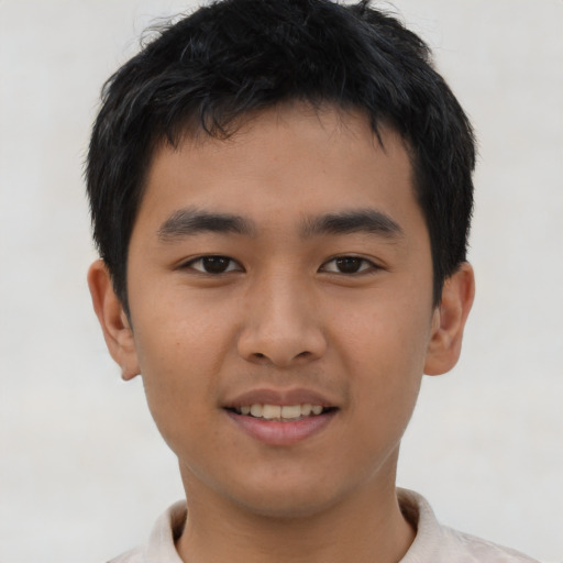 Joyful asian young-adult male with short  brown hair and brown eyes