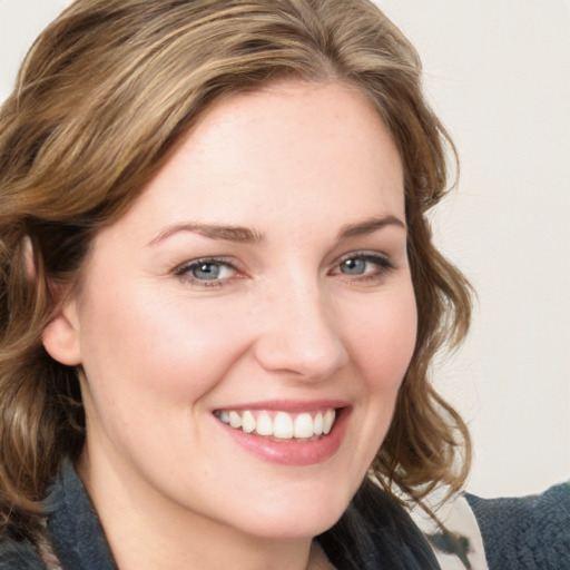 Joyful white young-adult female with medium  brown hair and blue eyes