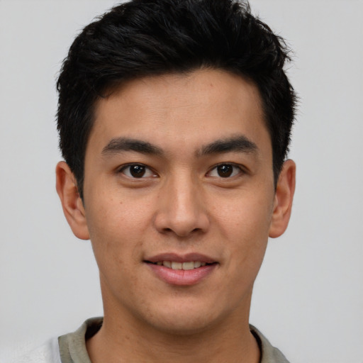 Joyful latino young-adult male with short  brown hair and brown eyes