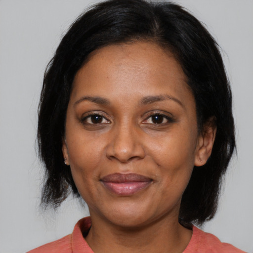Joyful asian adult female with medium  black hair and brown eyes