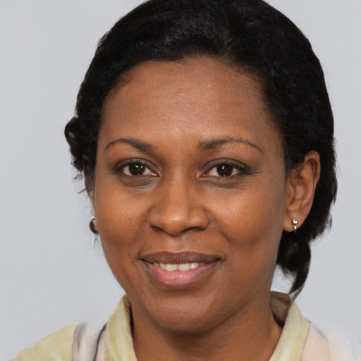 Joyful black adult female with medium  black hair and brown eyes