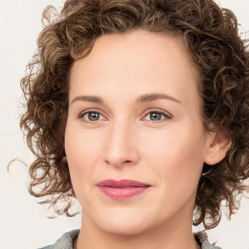 Joyful white young-adult female with medium  brown hair and green eyes