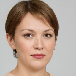 Joyful white adult female with medium  brown hair and grey eyes