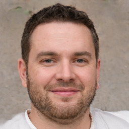 Joyful white adult male with short  brown hair and brown eyes