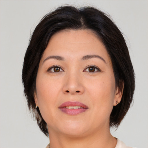 Joyful asian adult female with medium  brown hair and brown eyes