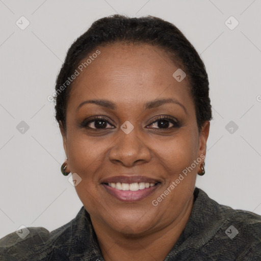 Joyful black adult female with short  brown hair and brown eyes