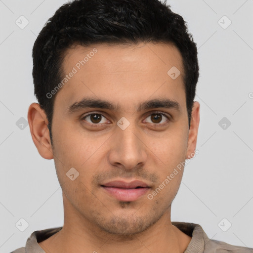 Joyful latino young-adult male with short  brown hair and brown eyes