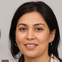 Joyful white adult female with medium  brown hair and brown eyes