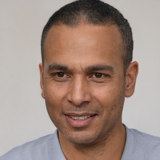 Joyful latino adult male with short  black hair and brown eyes