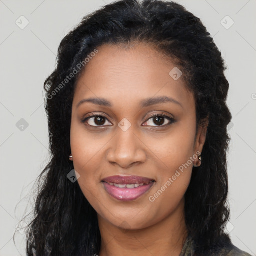 Joyful black young-adult female with long  brown hair and brown eyes