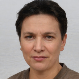 Joyful white adult female with short  brown hair and brown eyes