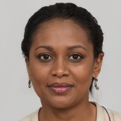 Joyful black young-adult female with short  brown hair and brown eyes