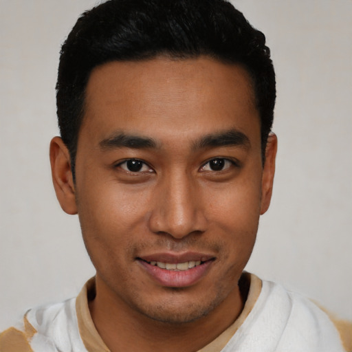 Joyful latino young-adult male with short  black hair and brown eyes