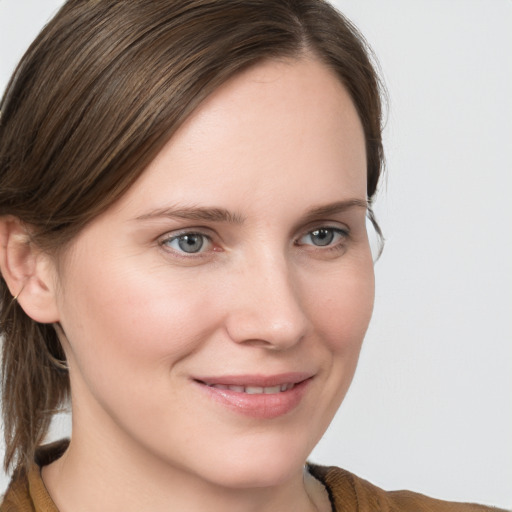 Joyful white young-adult female with medium  brown hair and blue eyes