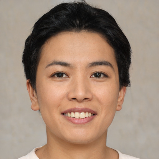 Joyful asian young-adult female with short  black hair and brown eyes