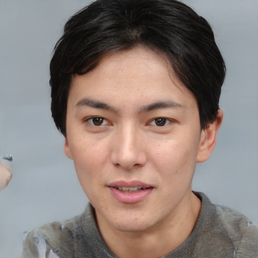 Joyful asian young-adult male with short  brown hair and brown eyes