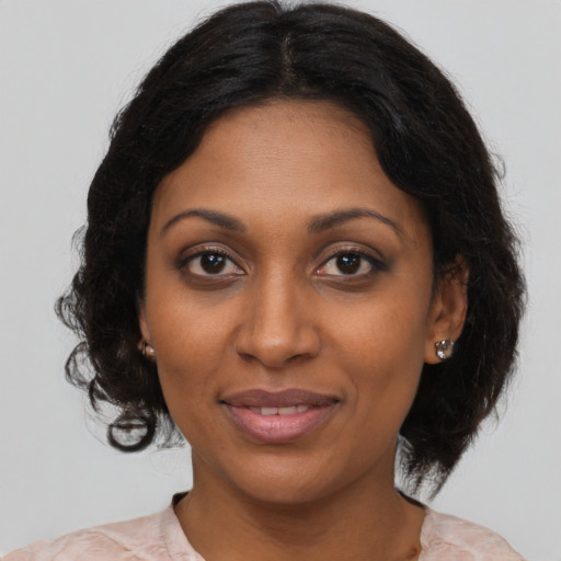 Joyful black young-adult female with medium  brown hair and brown eyes