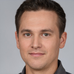 Joyful white adult male with short  brown hair and brown eyes