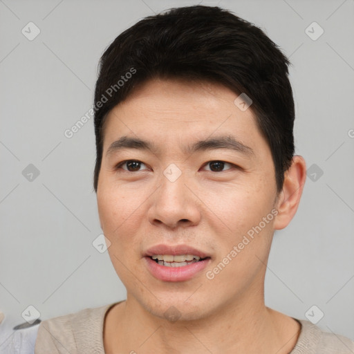 Joyful asian young-adult male with short  black hair and brown eyes