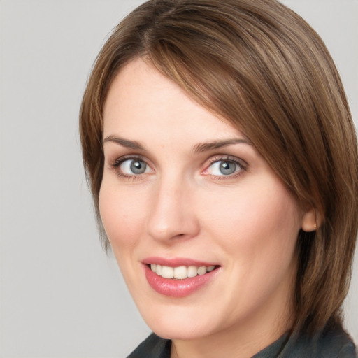 Joyful white young-adult female with medium  brown hair and blue eyes