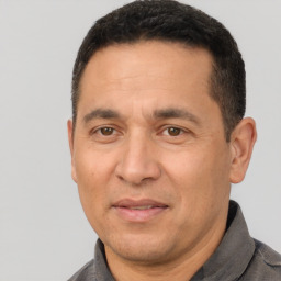 Joyful white adult male with short  black hair and brown eyes