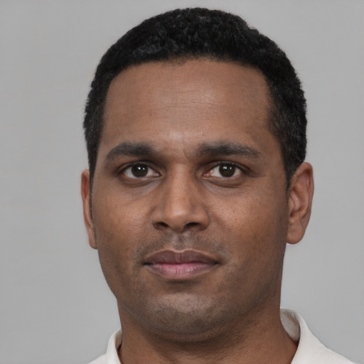 Neutral black adult male with short  black hair and brown eyes