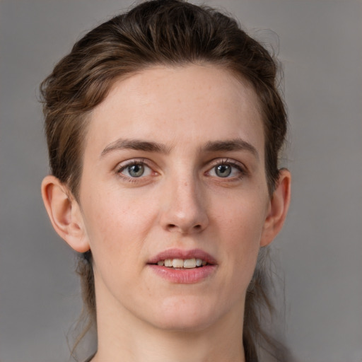 Joyful white young-adult female with medium  brown hair and grey eyes