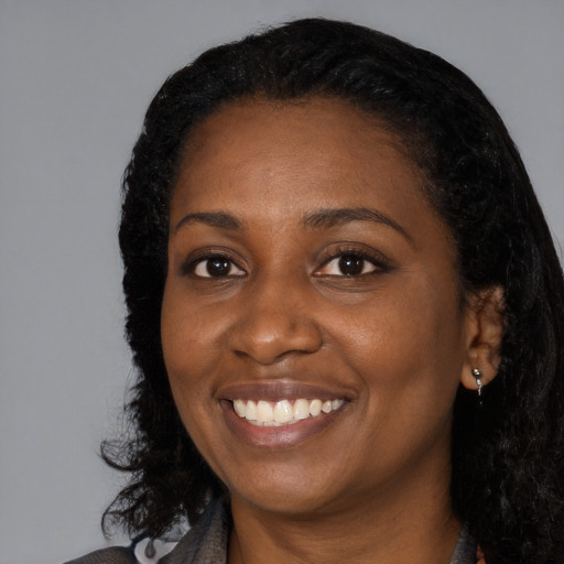 Joyful black young-adult female with medium  black hair and brown eyes