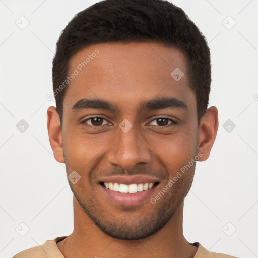 Joyful black young-adult male with short  brown hair and brown eyes