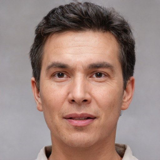 Joyful white adult male with short  brown hair and brown eyes