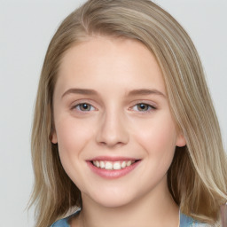 Joyful white young-adult female with medium  brown hair and blue eyes